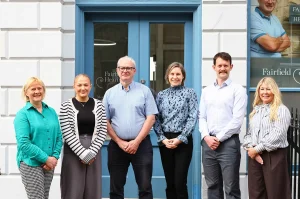 The Fairfield Hearing team standing outside the Edinburgh hearing clinic, including HCPC-registered audiologists and support staff providing independent hearing care.